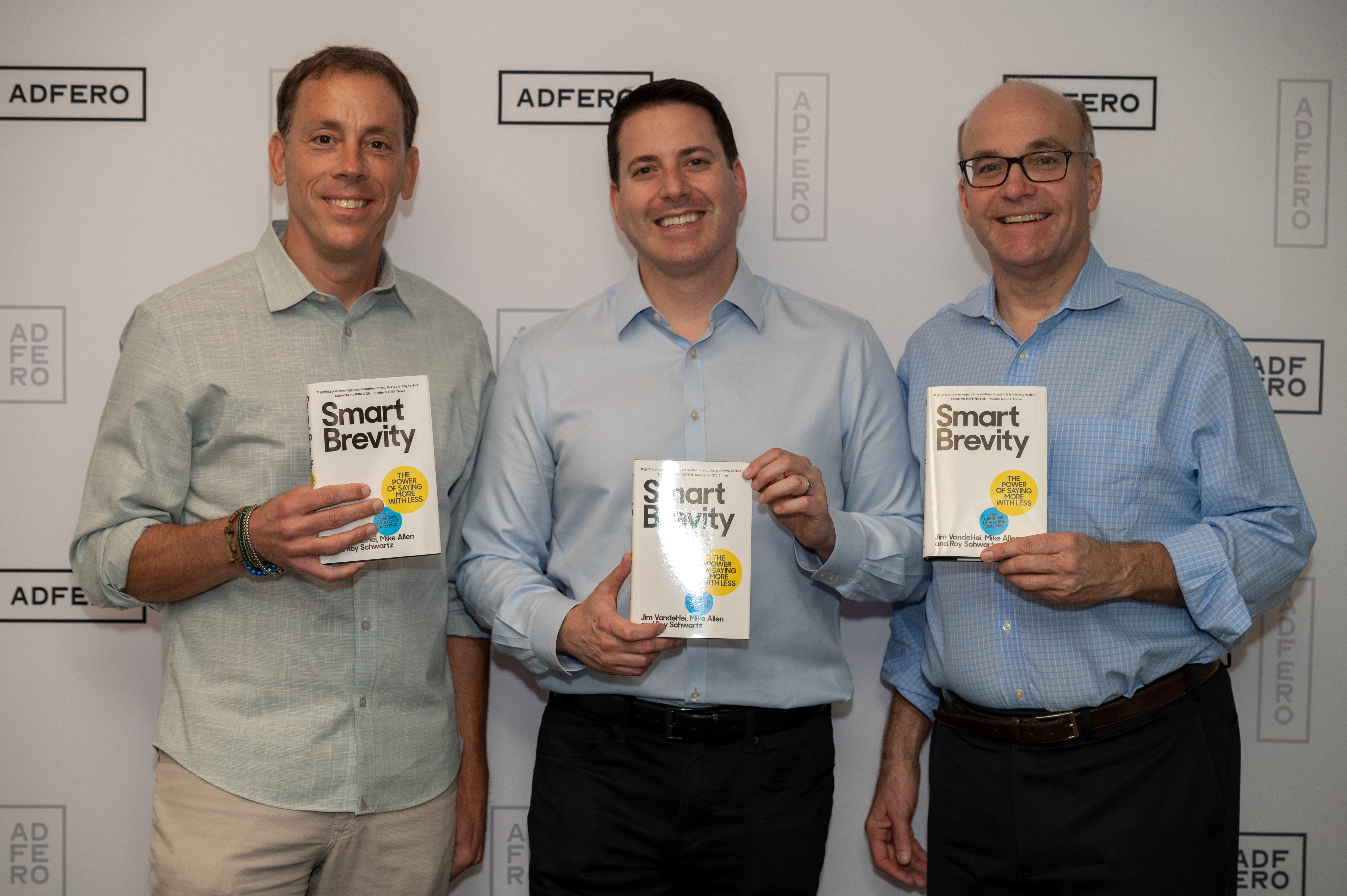 Adero Smart Brevity Event - Jim VandeHei, Roy Schwartz and Mike Allen, co-founders of Axios stand with their book Smart Brevity, The Power of Saying More With Less