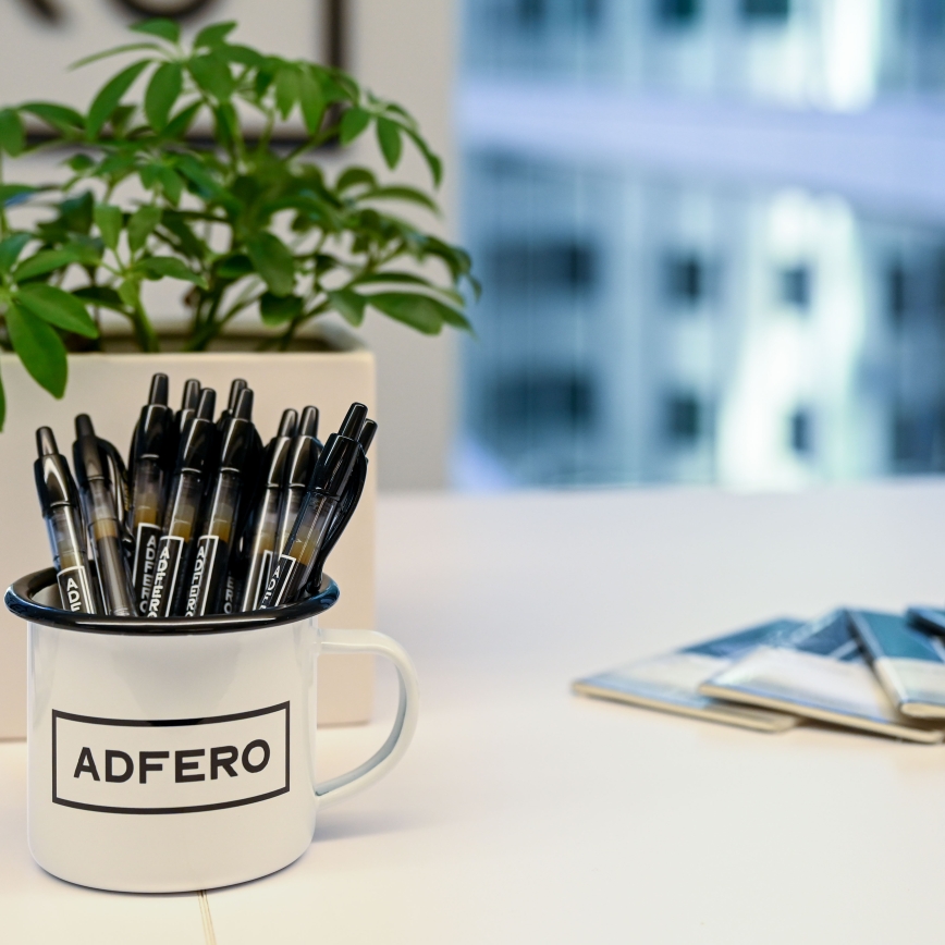 Table with notebooks, pens, and a plant
